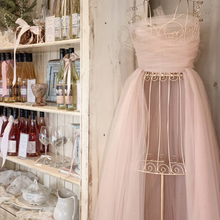 Load image into Gallery viewer, A display of wine and pretty bows with a mannequin dressed in pink tule.